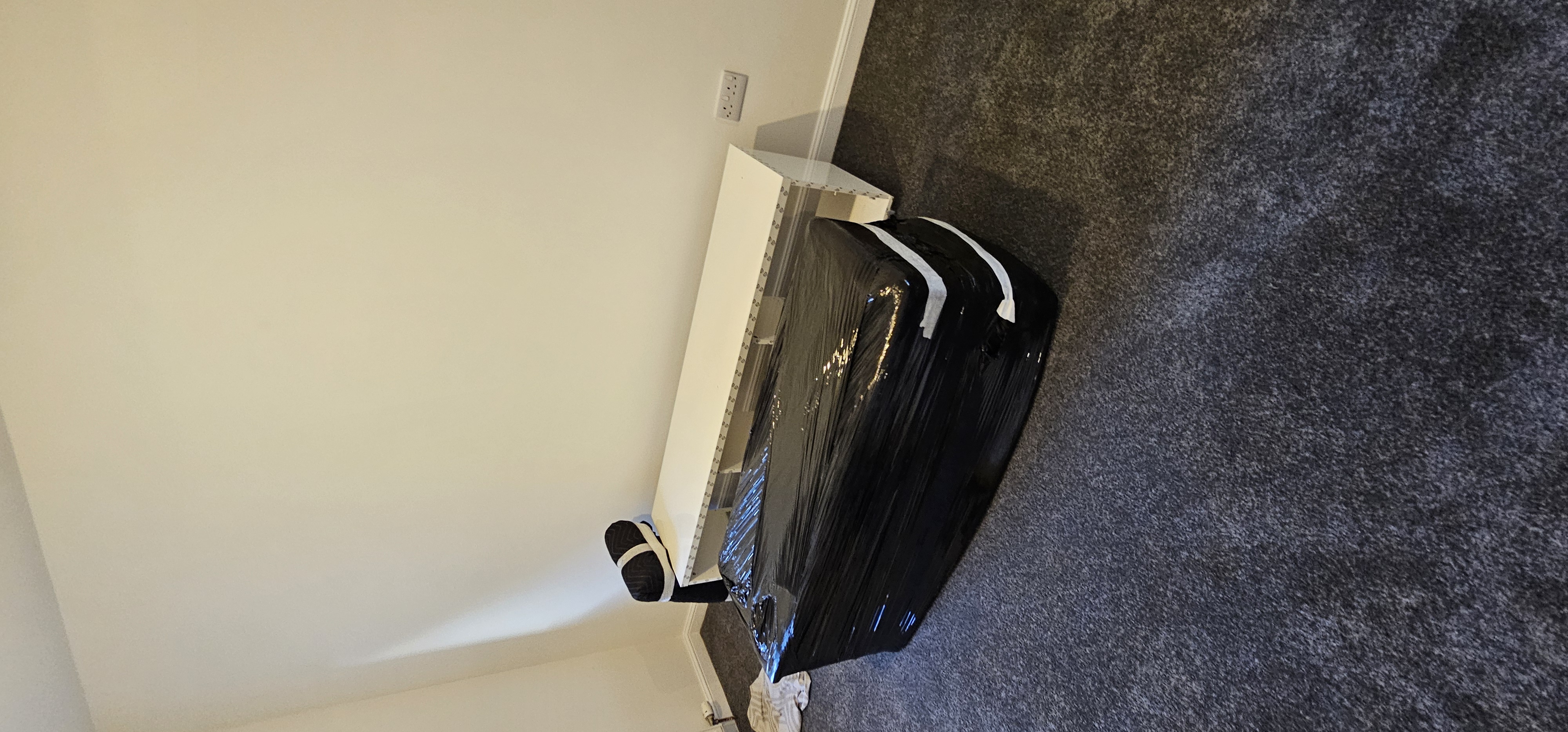 Furniture wrapped in protective covers ready for collection