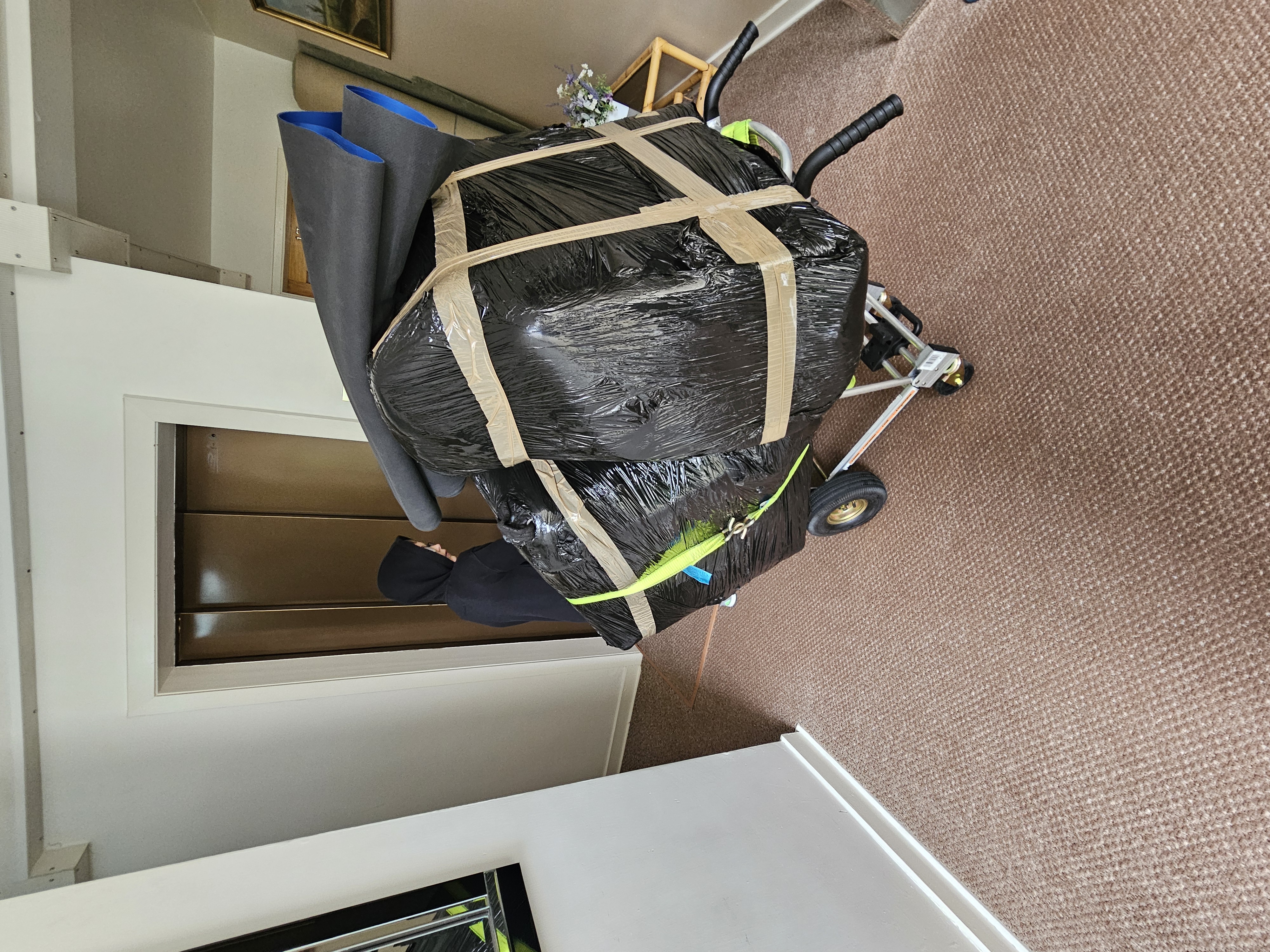 Large item wrapped and secured on sack truck in lift lobby