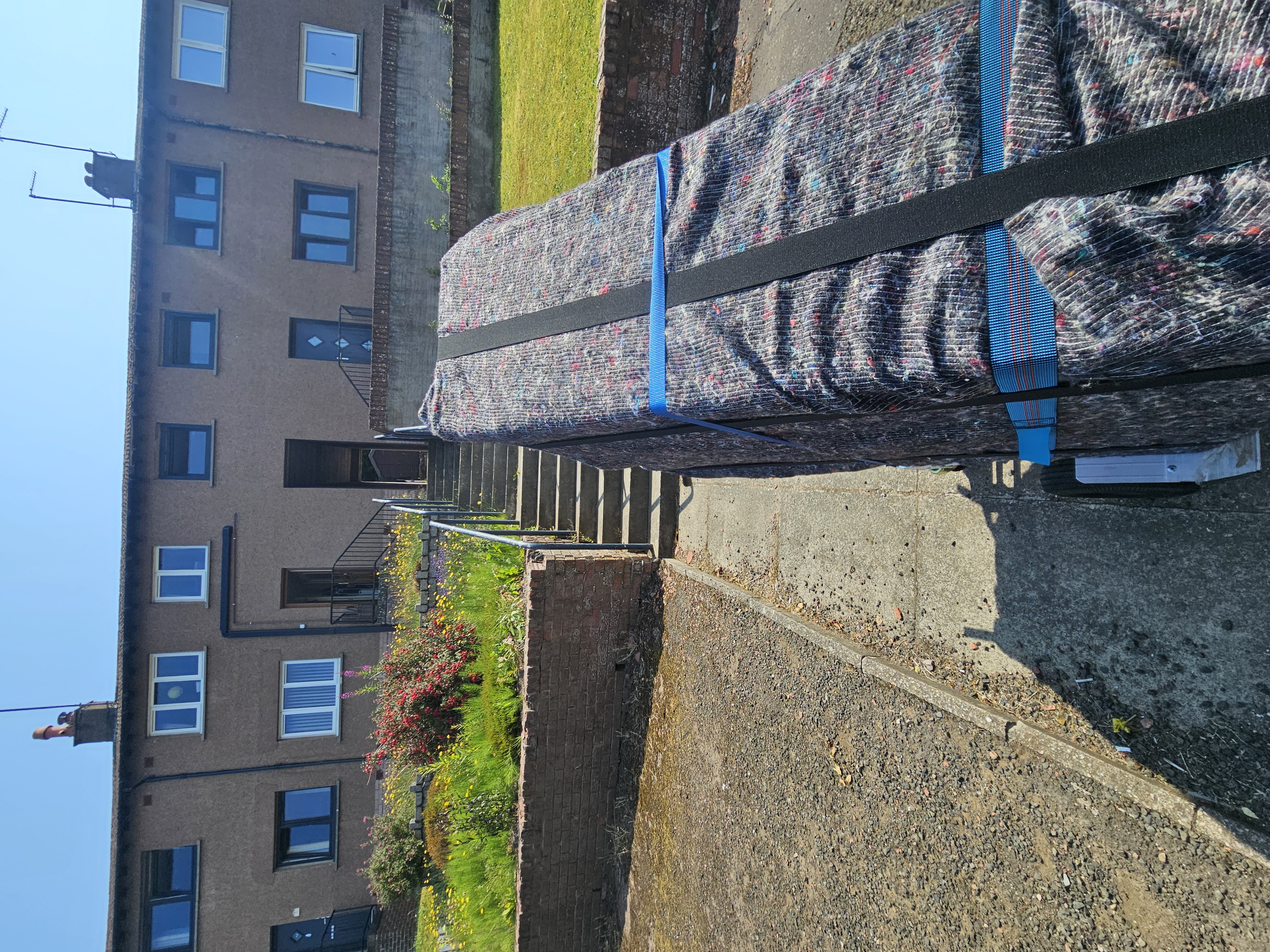 Protected mattress on the tailgate ready for loading