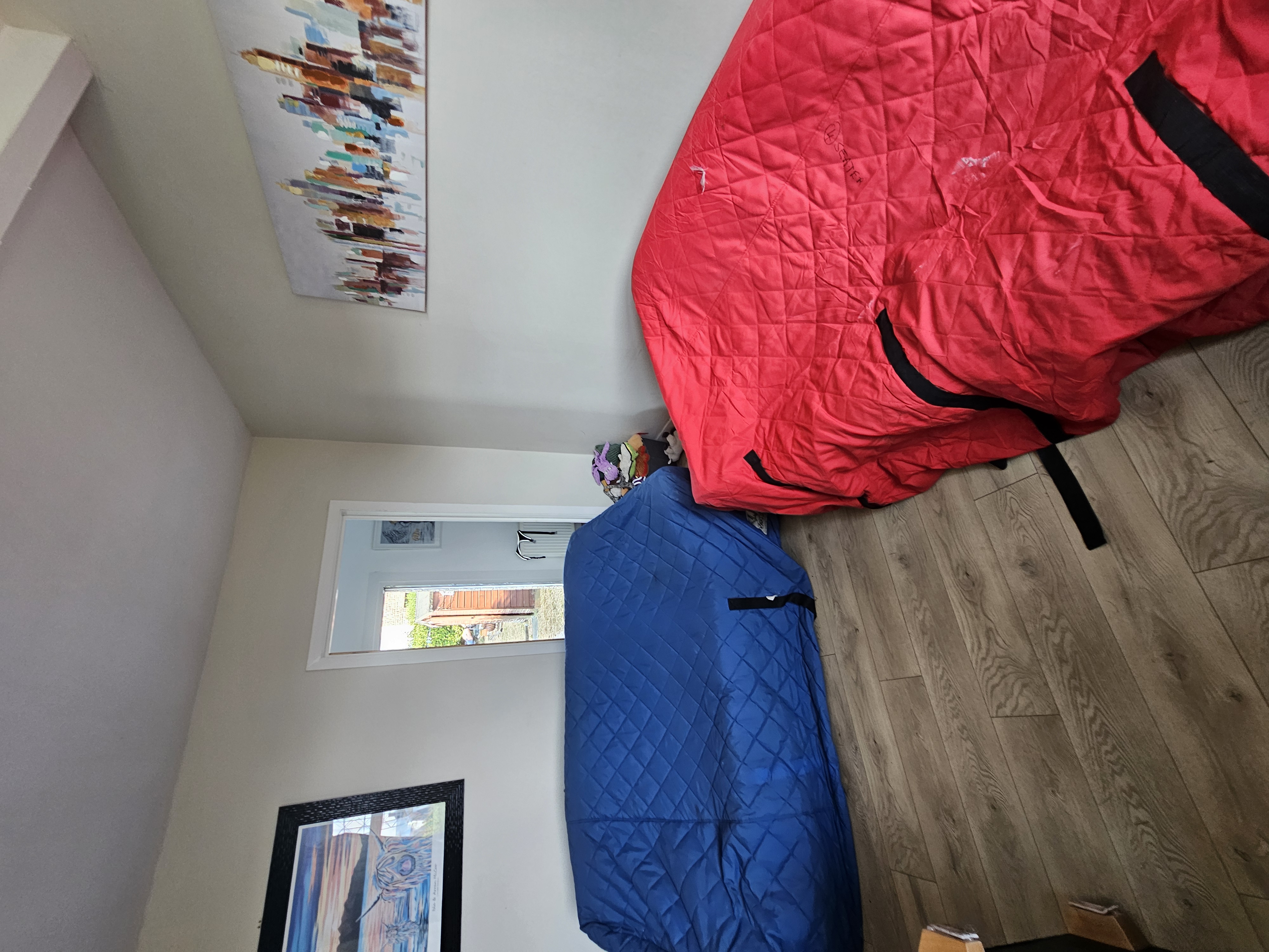 Sofas wrapped in protective covers inside a property