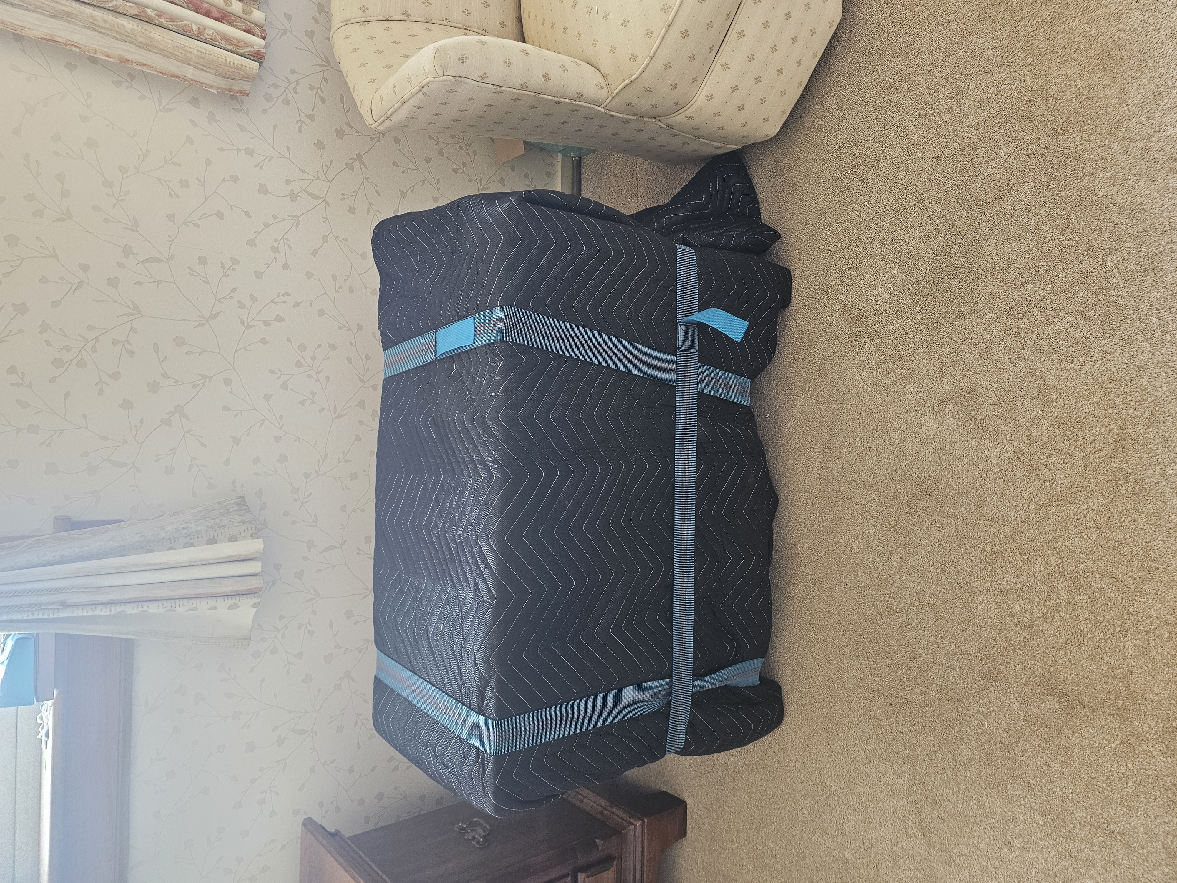 Item fully wrapped and secured in protective blanket cover