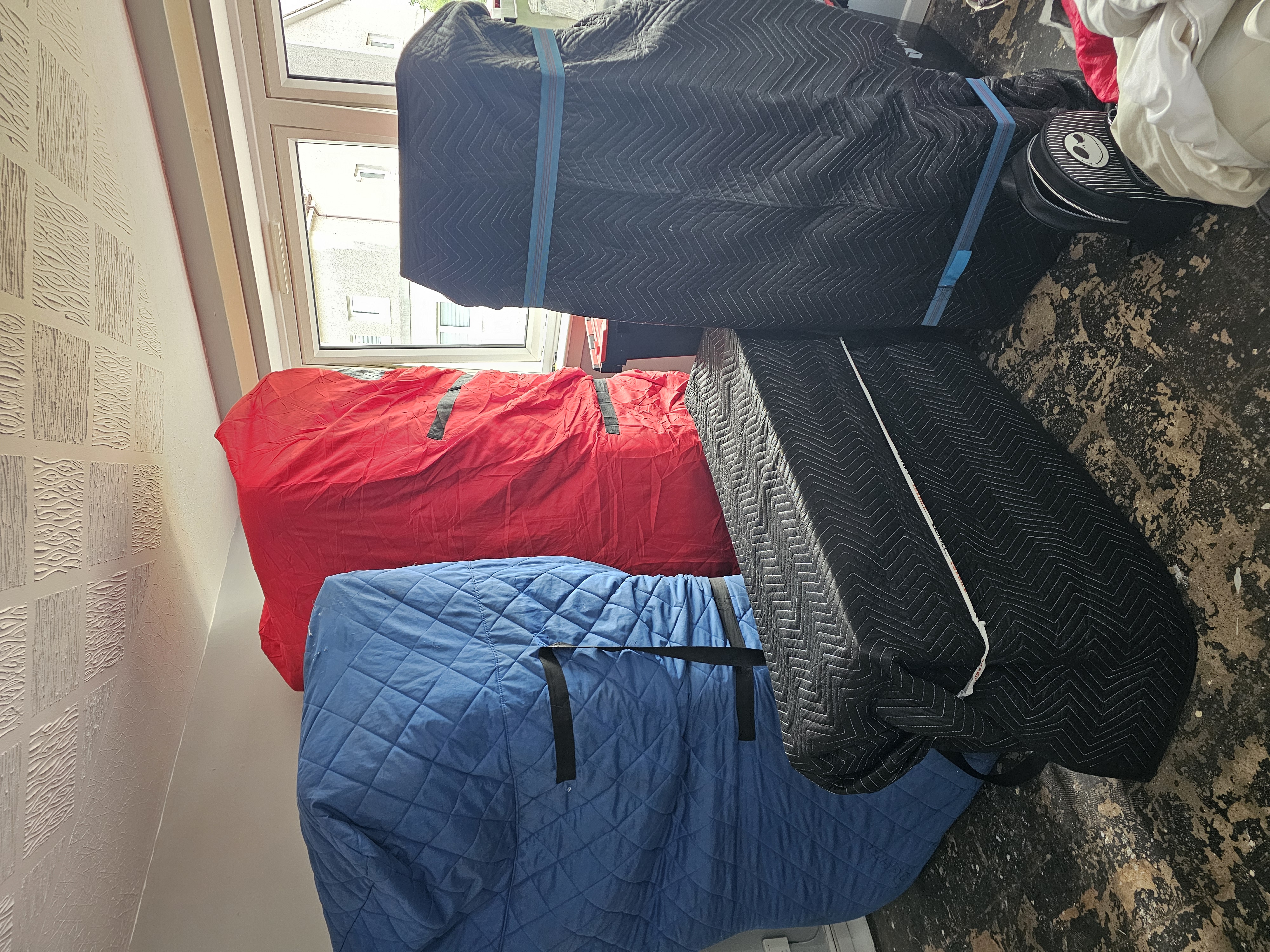 Multiple items in protective covers staged for loading