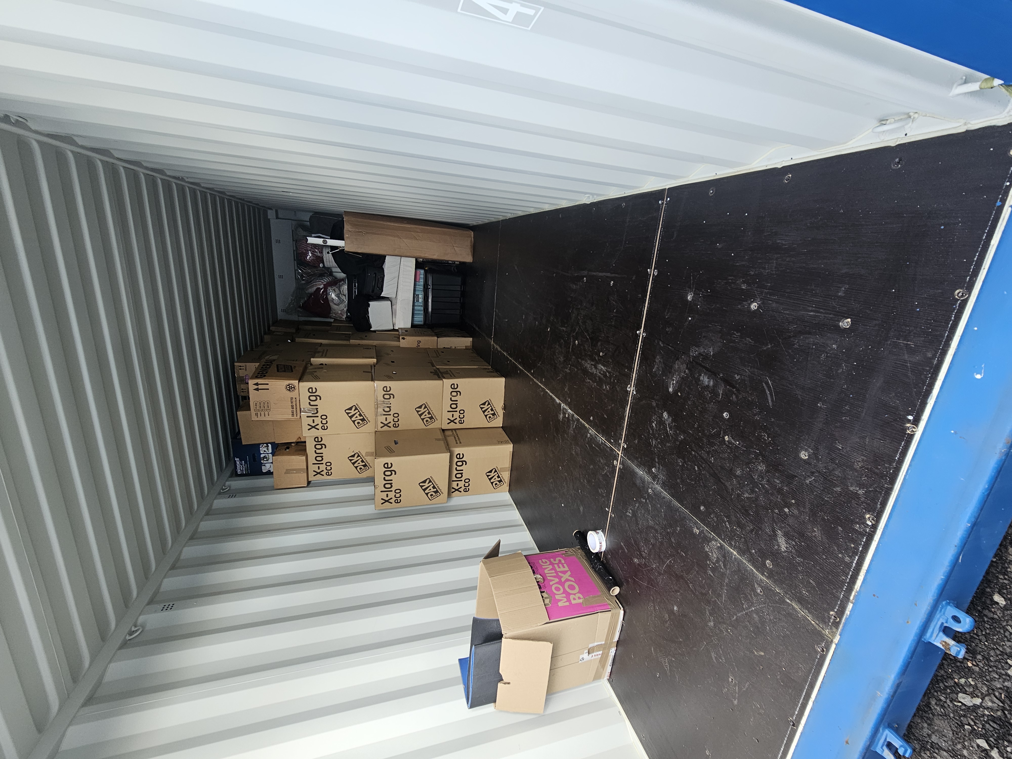 Storage container loaded with moving boxes