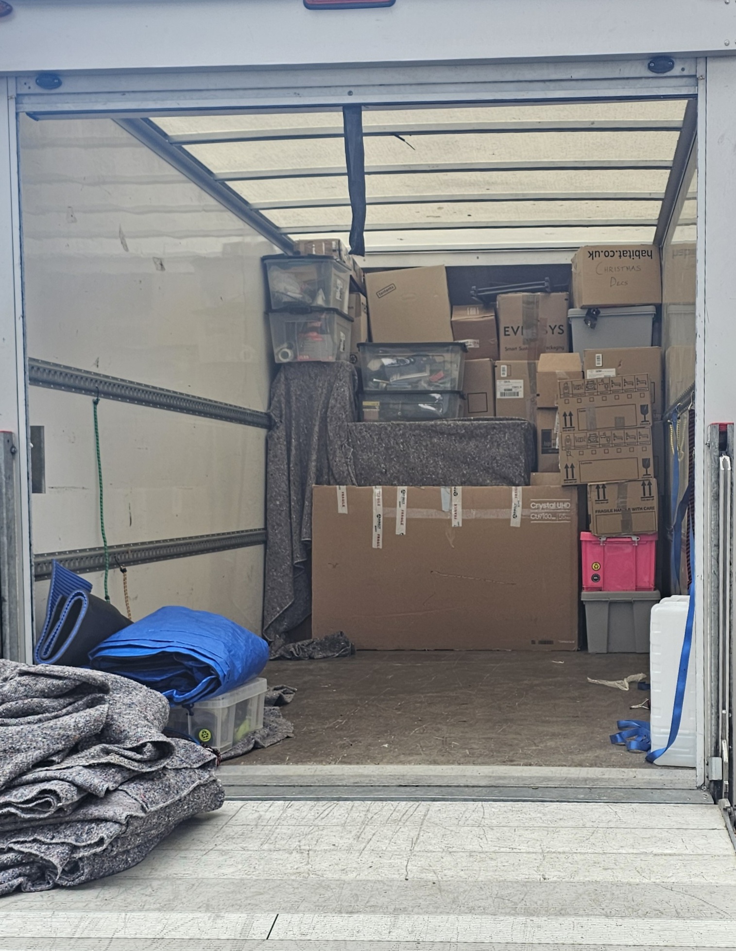 Luton van interior packed with boxes and removal equipment