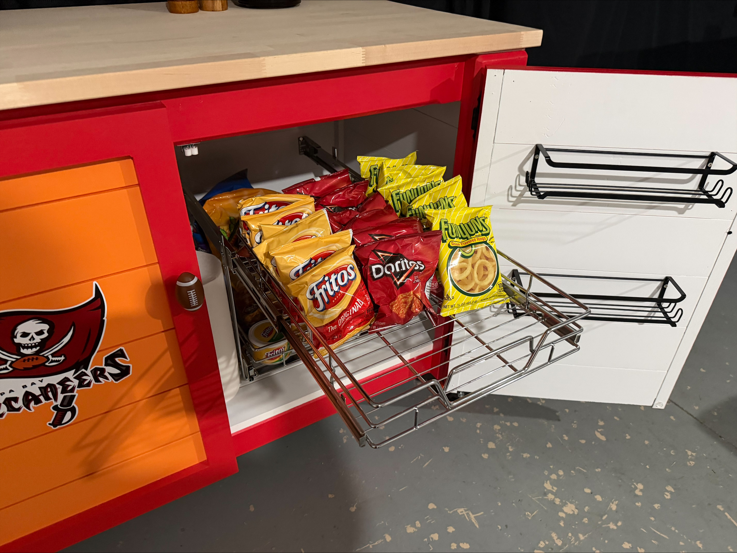 Interior of a personalized prep station showing pull-out chrome storage and door-mounted spice racks