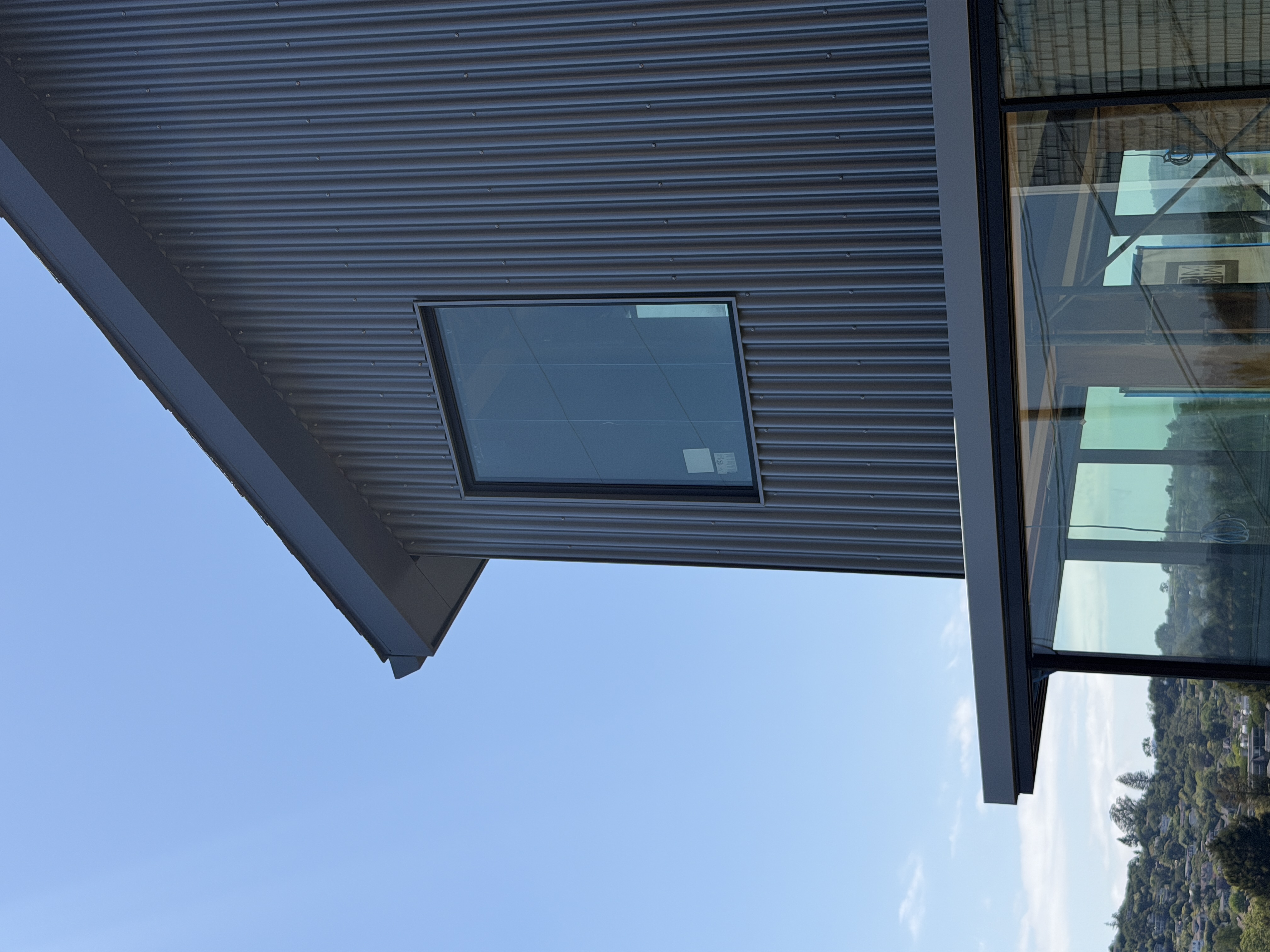 Corrugated metal siding panel detail in dark bronze finish