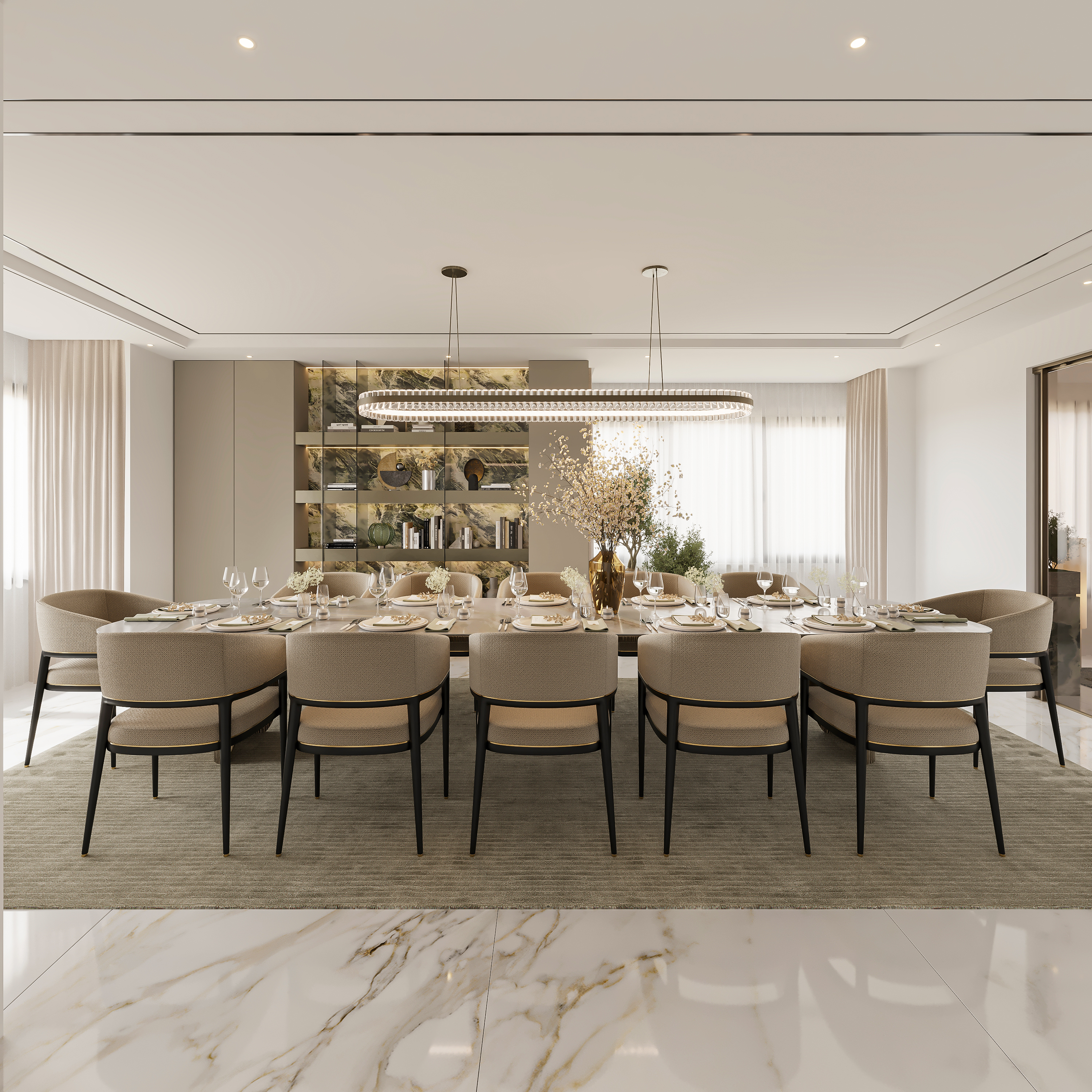 Symmetrical view of the dining table set for twelve, with bouclé chairs, a crystal ring chandelier, green marble display shelving and sheer curtains over marble flooring
