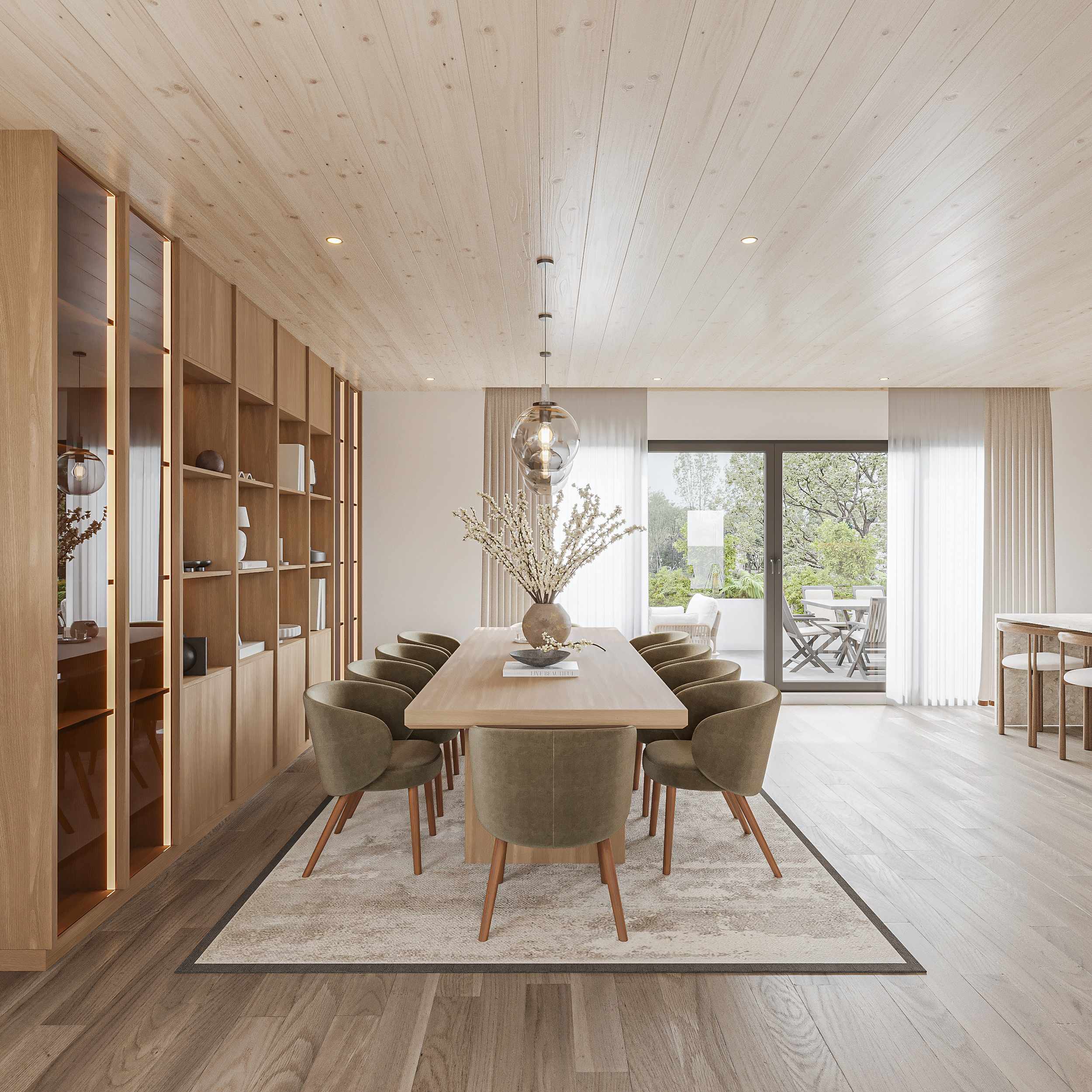Dining room with an oak table and olive velvet chairs on a soft bordered rug, LED-lit oak library joinery, glass globe pendant and sliding doors onto a covered terrace
