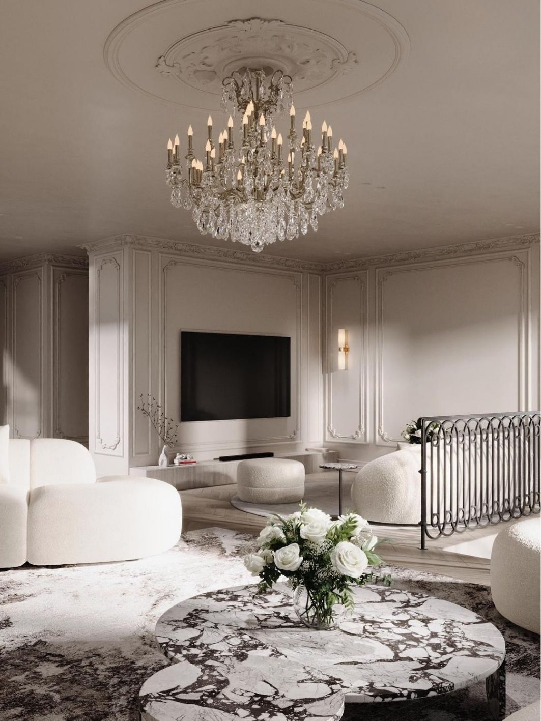 Sitting room with panelled plaster walls, a wall-mounted screen above a low plaster bench, rounded boucle seating, a violet-veined marble coffee table with white roses and a crystal chandelier