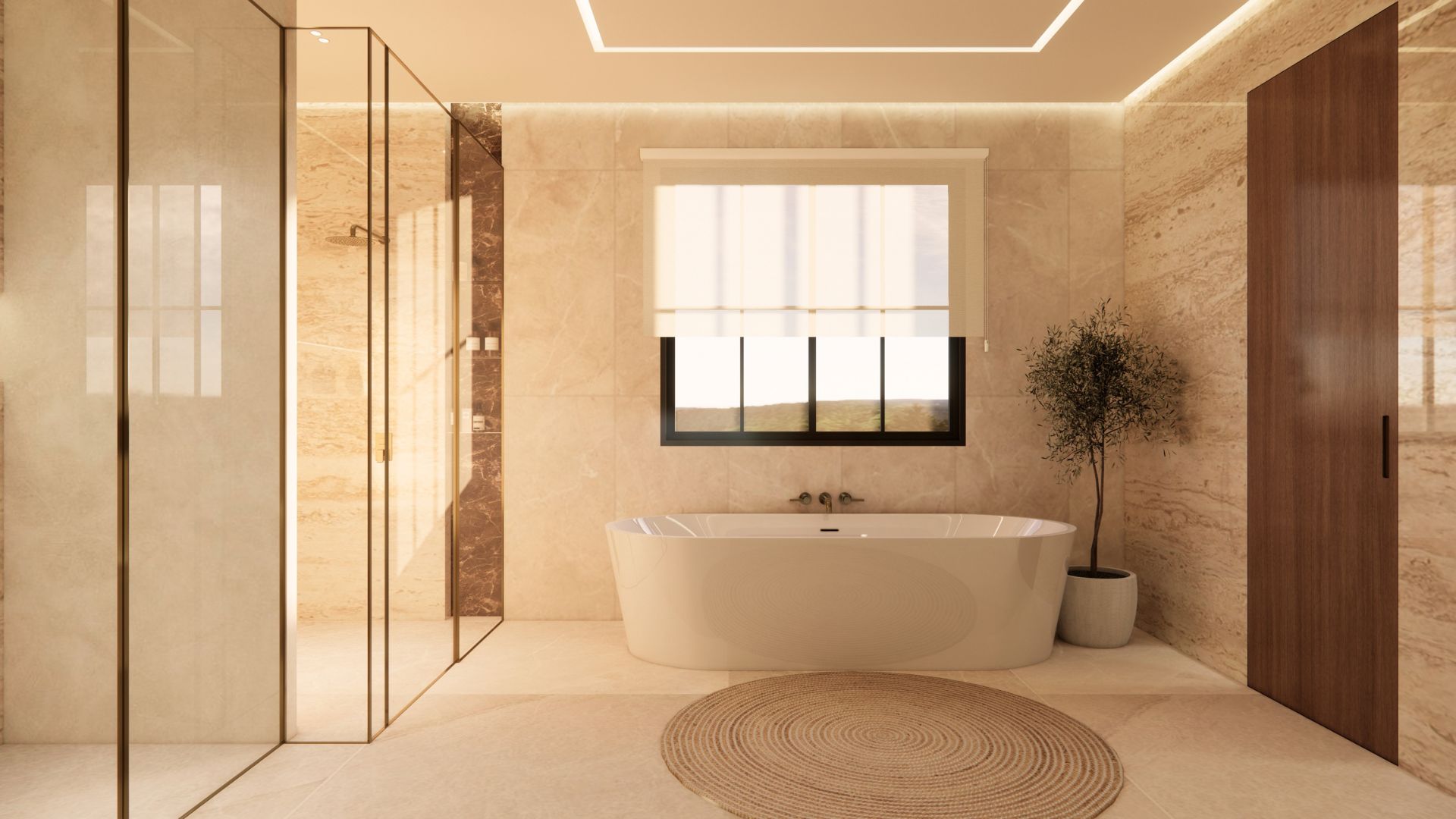 Bathroom with a freestanding oval tub below a linen roman blind, bronze wall filler, potted olive tree, brass-framed glass shower enclosure and a round jute rug on stone flooring