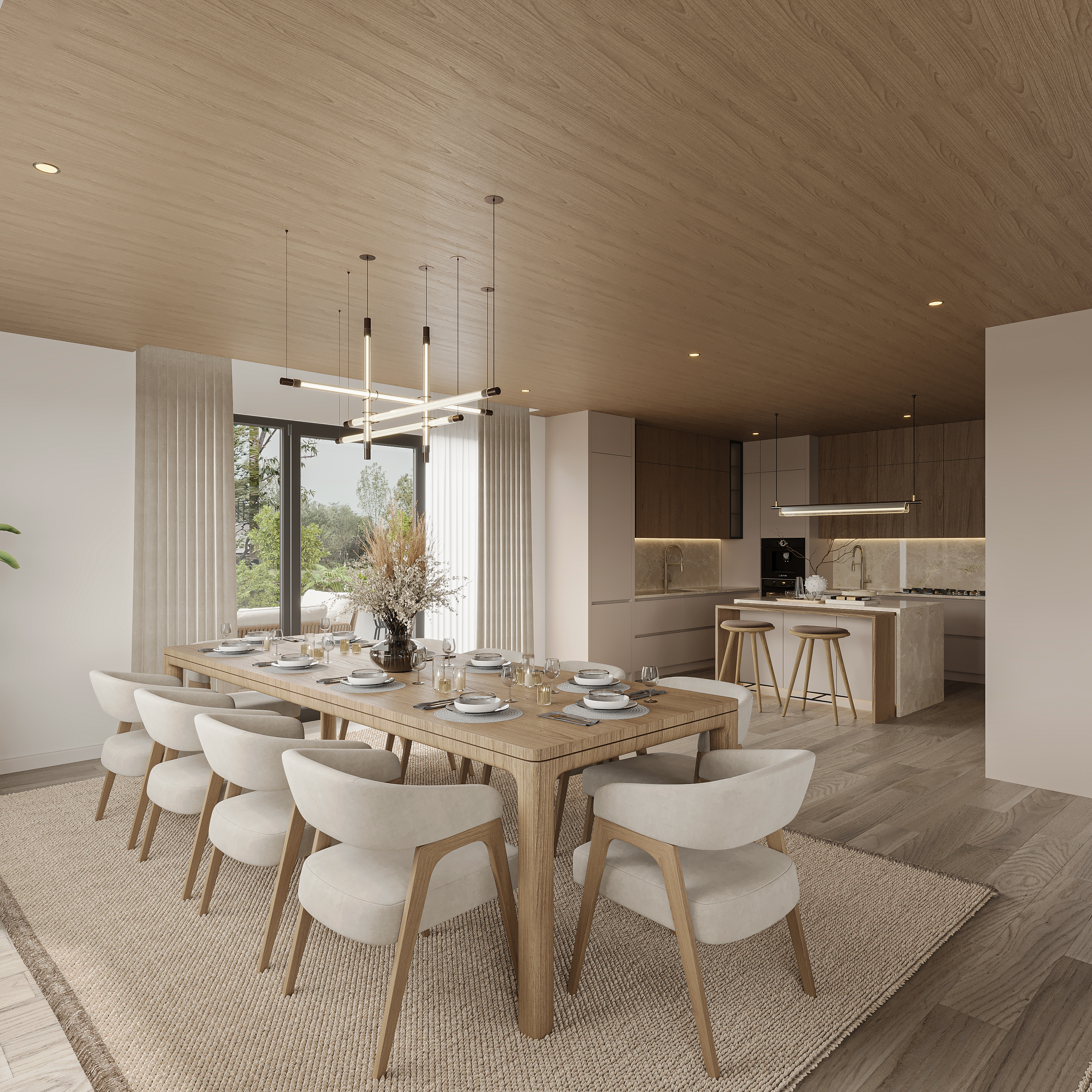 Dining area with a reeded oak table and cream armchairs on a woven rug, linear pendant bars overhead, and the walnut kitchen with stone island and oak stools beyond