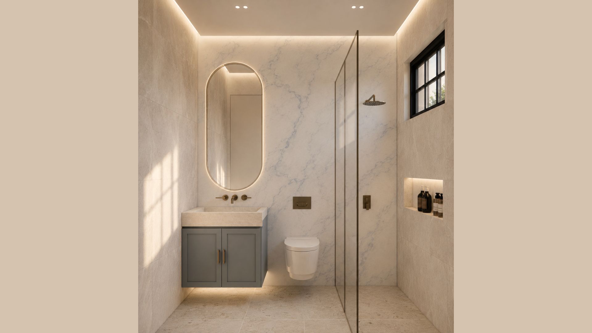 Shower room in pale marble with a backlit oval mirror, stone basin on a grey shaker vanity, bronze wall taps, wall-hung WC and a frameless glass walk-in shower with a lit niche