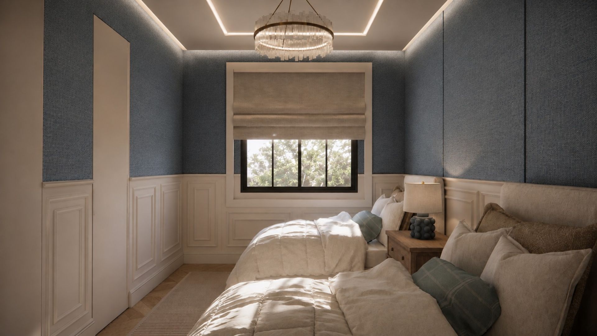Twin bedroom looking to a black-framed window with a linen roman blind, blue panelled walls, quilted bedding with sage cushions, an oak nightstand and a crystal ring chandelier