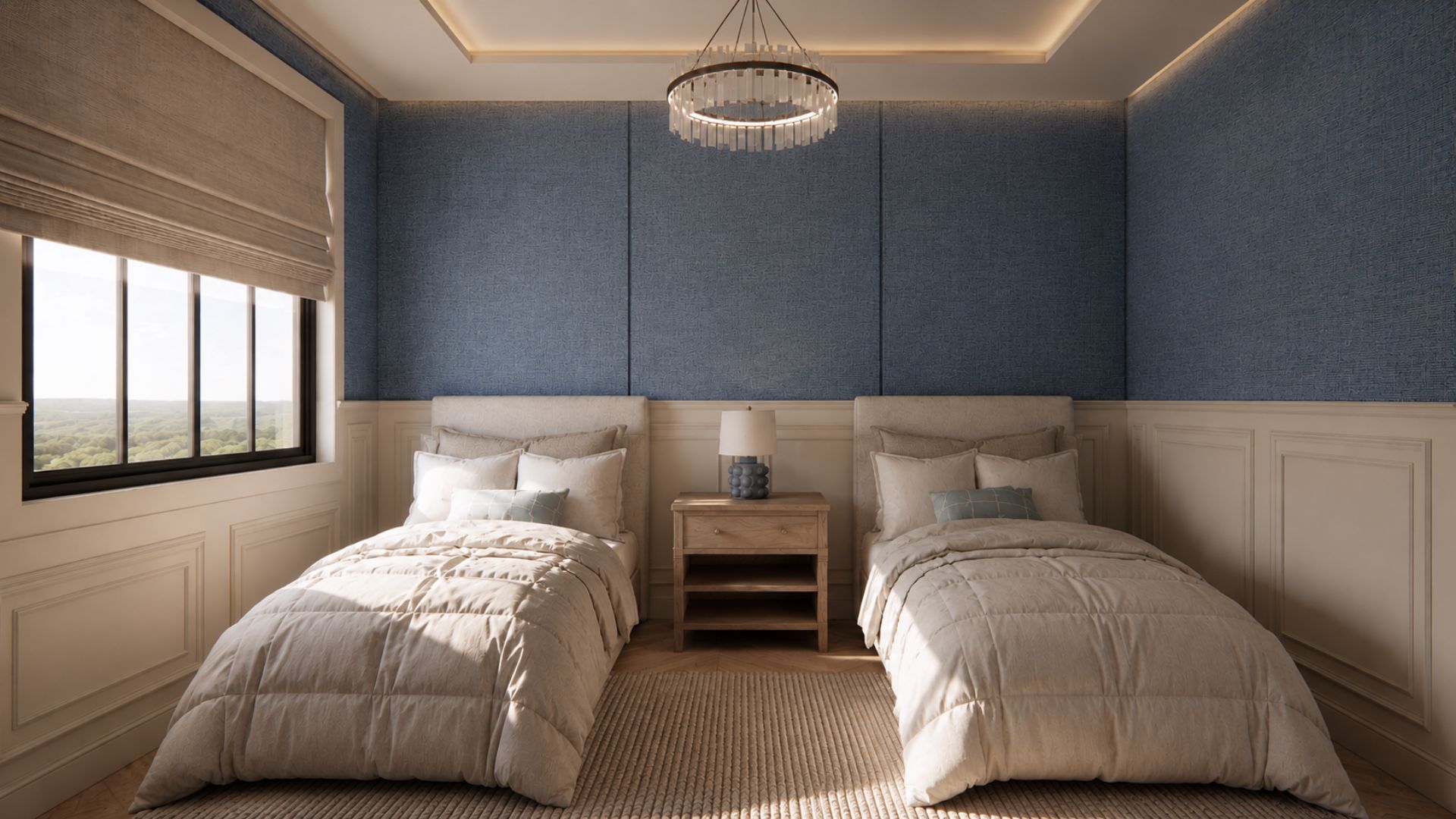 Twin bedroom with blue textile-panelled walls above cream wainscoting, upholstered headboards, quilted ivory bedding, a shared oak nightstand and a crystal ring chandelier over a woven rug