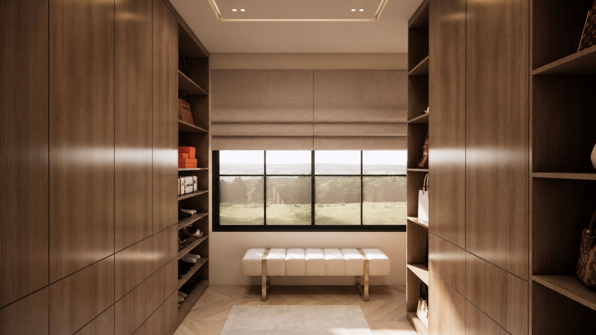 Walk-in wardrobe with oak cabinetry and open shoe shelving either side, a white leather bench on brass legs and a black-framed window with a linen roman blind onto meadow
