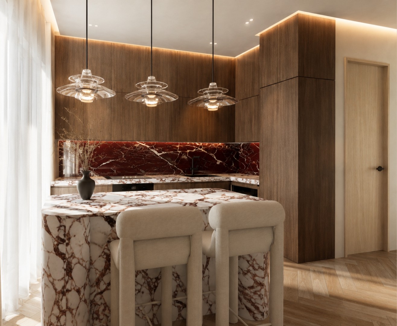 Kitchen corner with a marble waterfall island and bouclé stools, full-height walnut joinery with cove lighting, deep red marble splashback and three tiered glass pendants