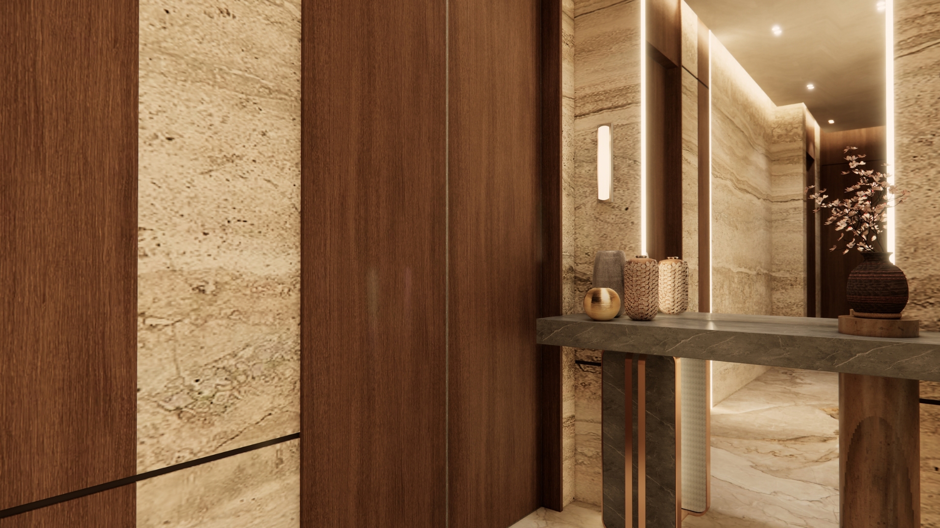 Lobby detail with walnut panelling set between travertine panels, a backlit mirror, dark green stone console with brass legs, ceramic vases and a blossom branch in a ribbed vessel