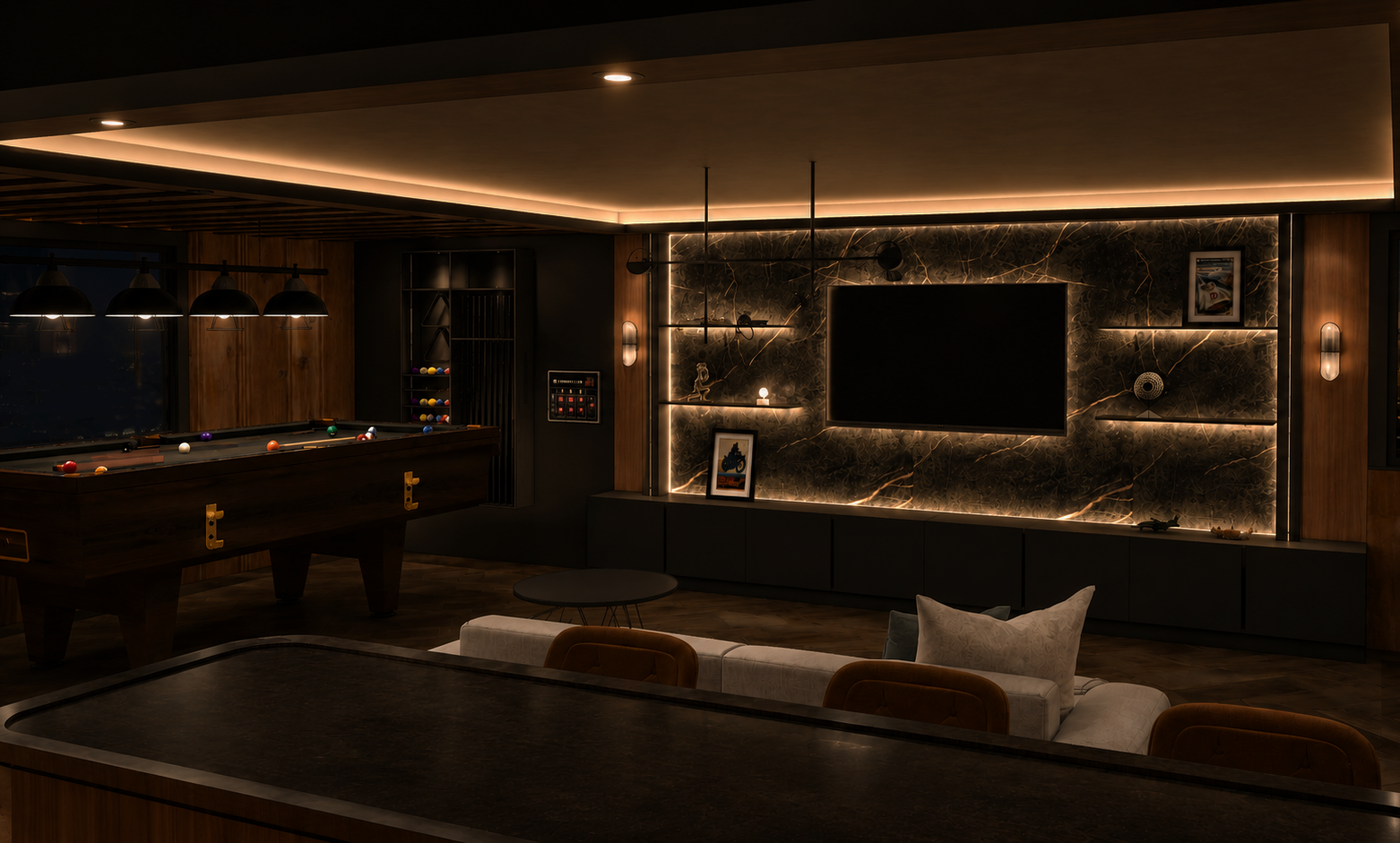 Basement games room with a backlit dark marble media wall and floating shelves, a walnut pool table, grey sofa with tan chairs and cove lighting overhead
