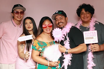 Five guests with baby-shower props at a GlamBooth celebration