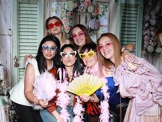 Five women with heart-shaped glasses at a GlamBooth birthday