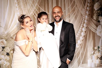 Bride holding a child with a groom at a GlamBooth wedding