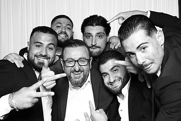 Six men in suits posing at a GlamBooth wedding