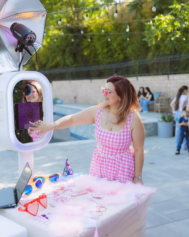 Guest using the GlamBooth photo booth at an outdoor event