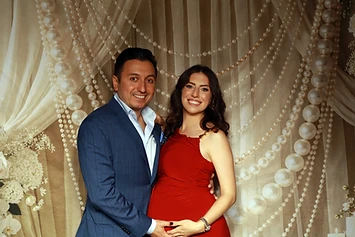 Couple expecting a baby at a GlamBooth wedding