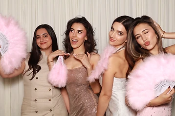 Guests posing with coordinated props at a GlamBooth milestone celebration