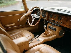 Restored vintage car interior with tan leather