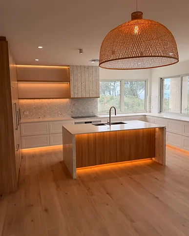 Kitchen island with pendant and under-bench lighting