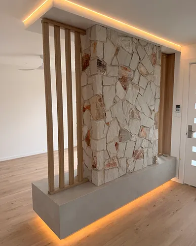Cove-lit stone feature wall and staircase