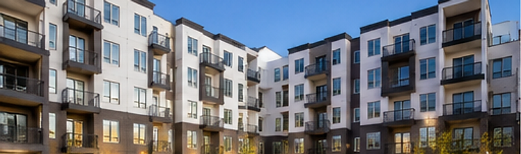 Completed apartment courtyard at dusk with warm landscape lighting