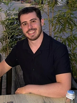 Nathan Batchelor, UGC creator, seated outdoors in warm light