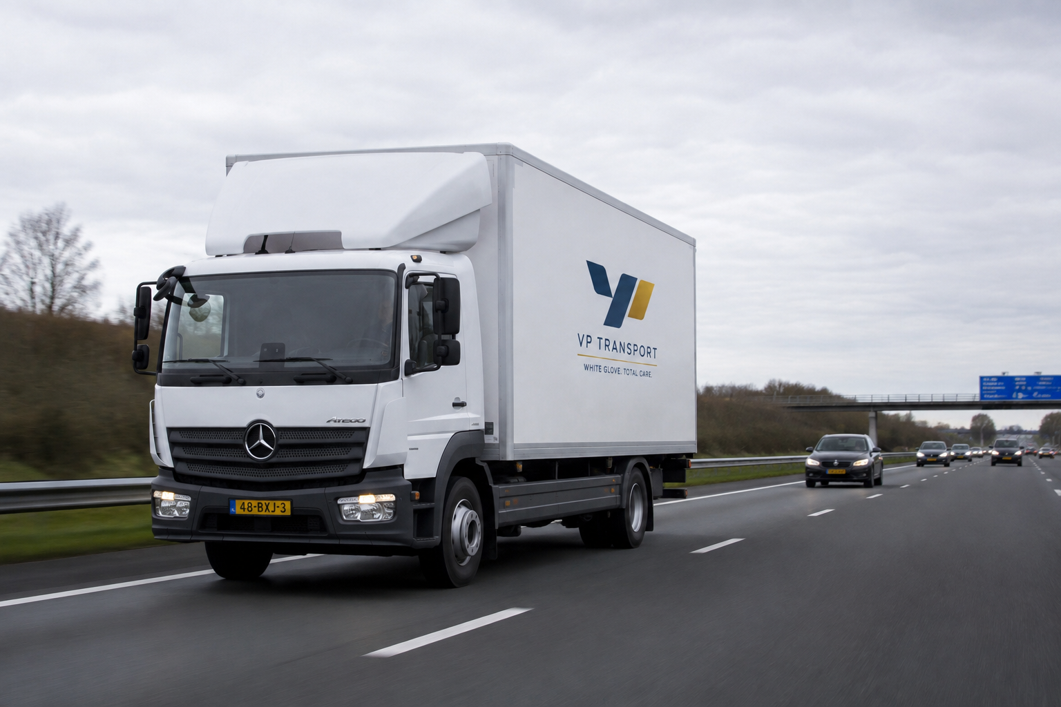 Our white glove delivery truck on the road, the VP Transport fleet in action.