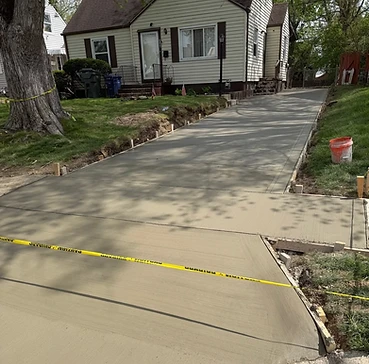 Newly poured concrete driveway installation