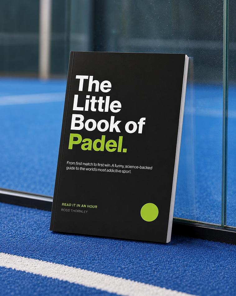 The Little Book of Padel resting against a glass court wall