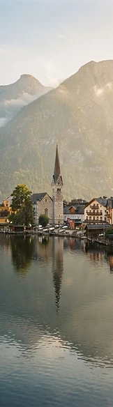 Hallstatt alpine village reflected in a calm lake at golden hour