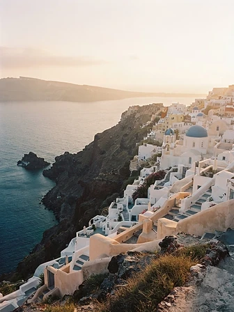 Whitewashed Greek island buildings with blue domes above the Aegean