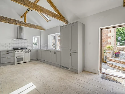 Kitchen with vaulted ceiling and exposed beams