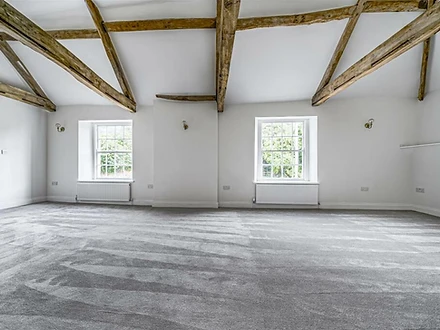Lounge with vaulted ceiling and sash windows