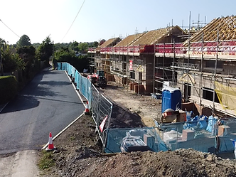 Residential development site under construction with scaffolding and blockwork