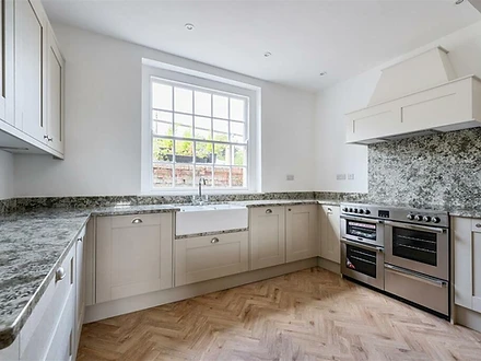 Kitchen with range cooker and herringbone floor