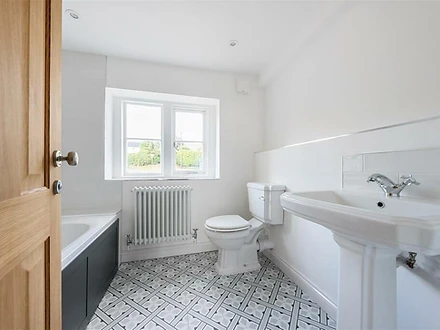 Family bathroom with patterned floor tiles