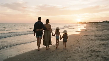Family walking along the beach at golden hour