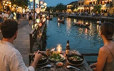 Riverside restaurants in Hoi An Ancient Town at dusk with lanterns reflecting on the Thu Bon River
