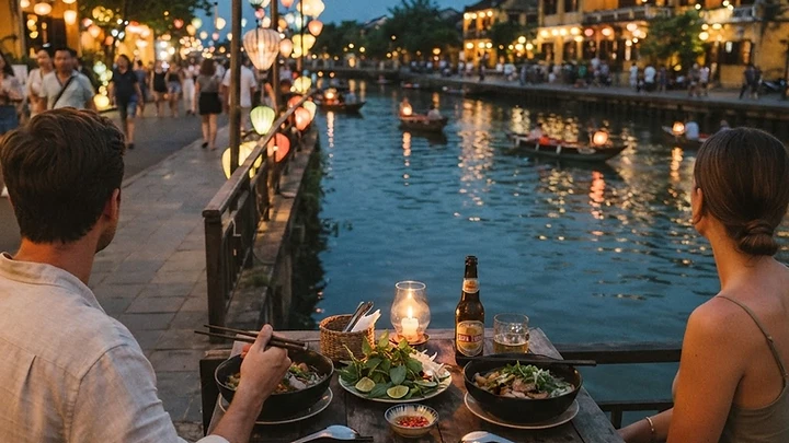 Riverside restaurants in Hoi An Ancient Town at dusk with lanterns reflecting on the Thu Bon River