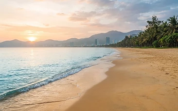 Wellness retreat da nang beach morning with calm sea and empty sand at sunrise