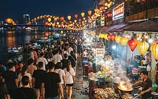 Son Tra Night Market stalls lit up at night along the Han River near Dragon Bridge in Da Nang
