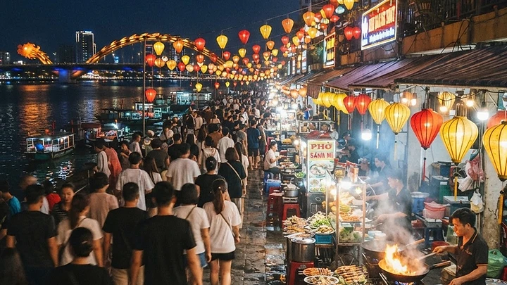 Son Tra Night Market stalls lit up at night along the Han River near Dragon Bridge in Da Nang